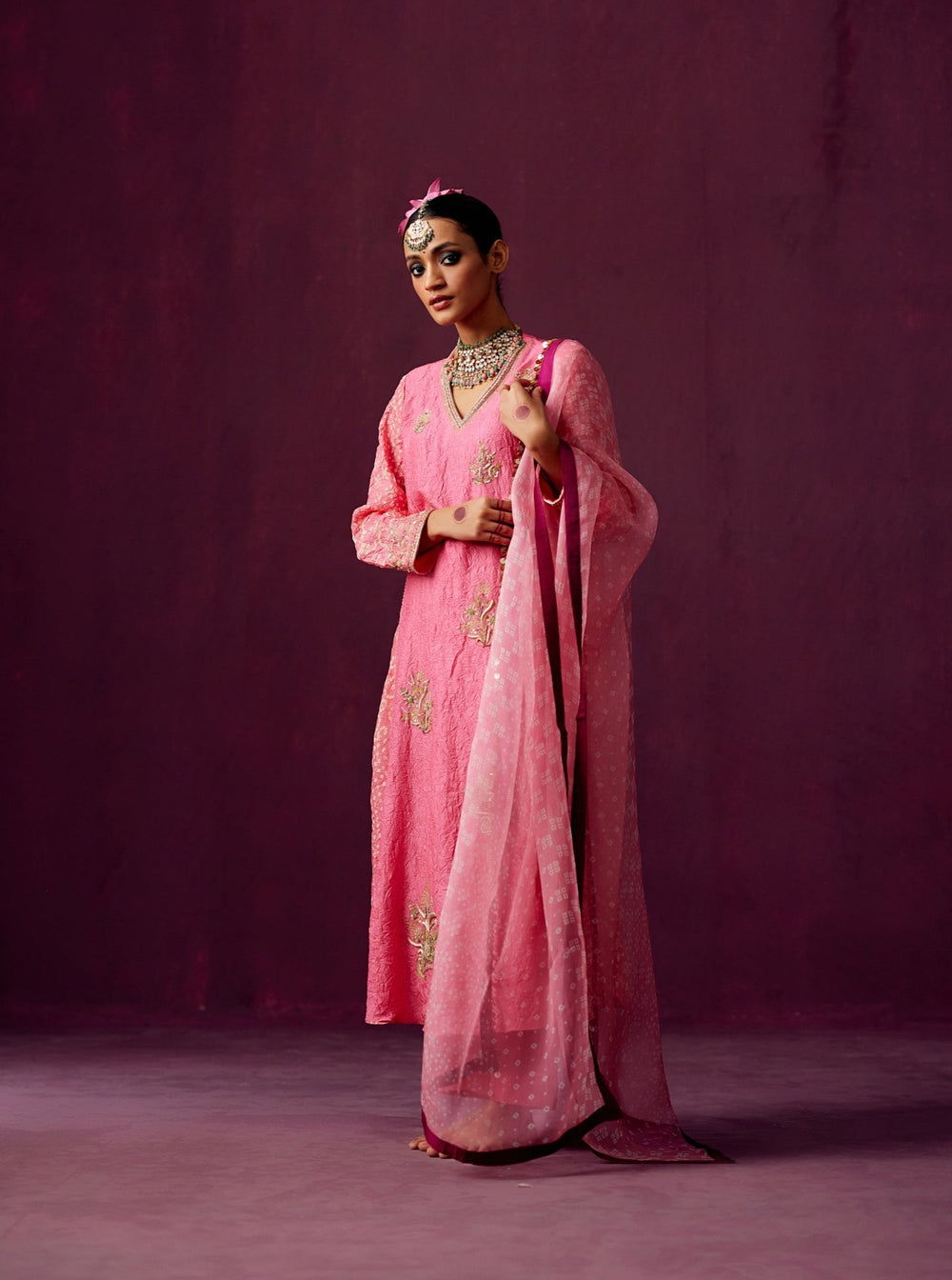 Pink kurta with Bandhej side panels, silk pant and bandhej print organza dupatta.