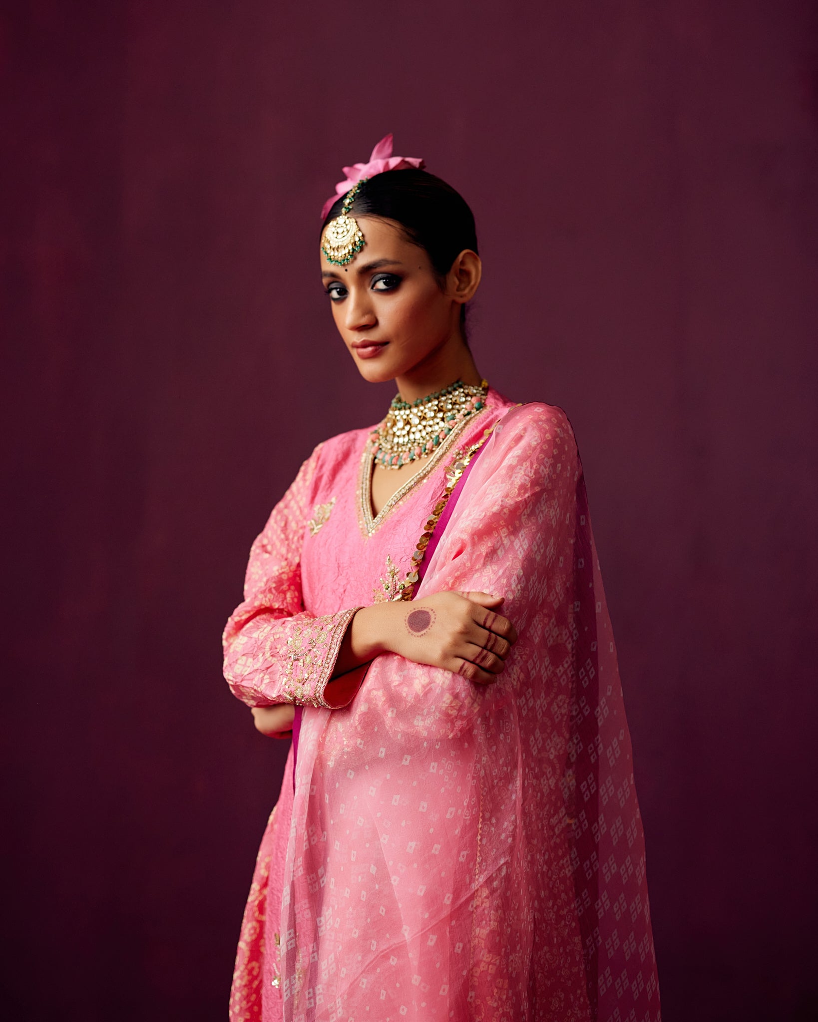 Pink kurta with Bandhej side panels, silk pant and bandhej print organza dupatta.