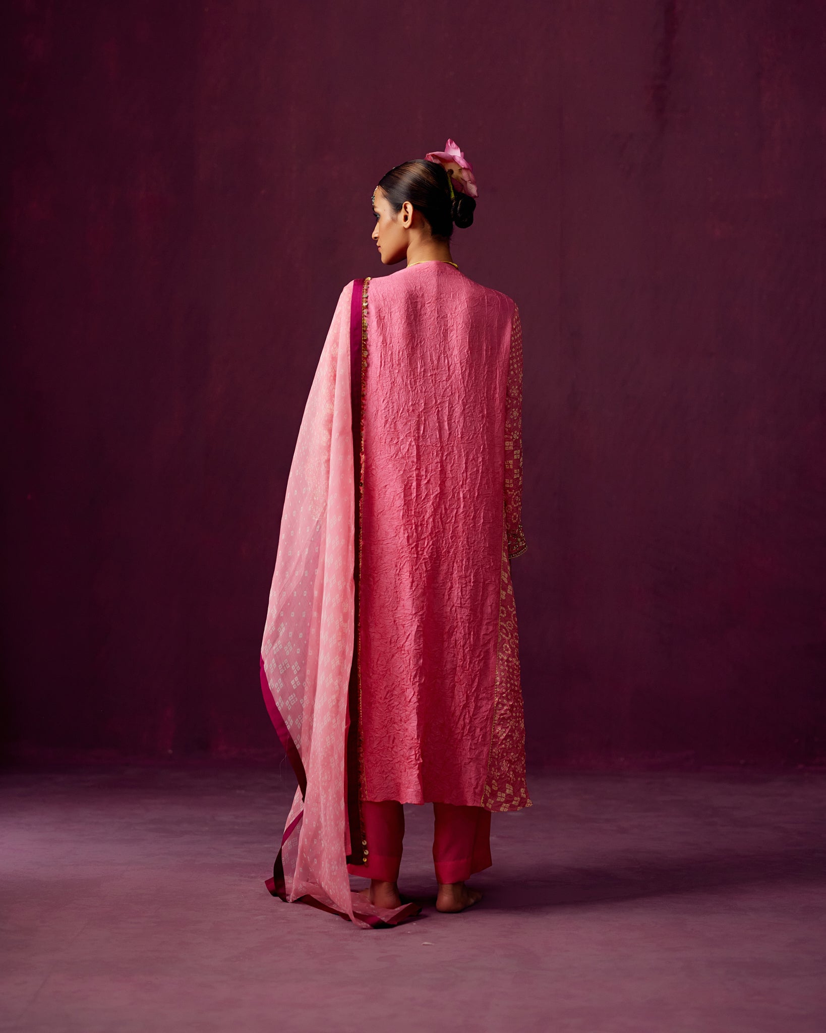 Pink kurta with Bandhej side panels, silk pant and bandhej print organza dupatta.