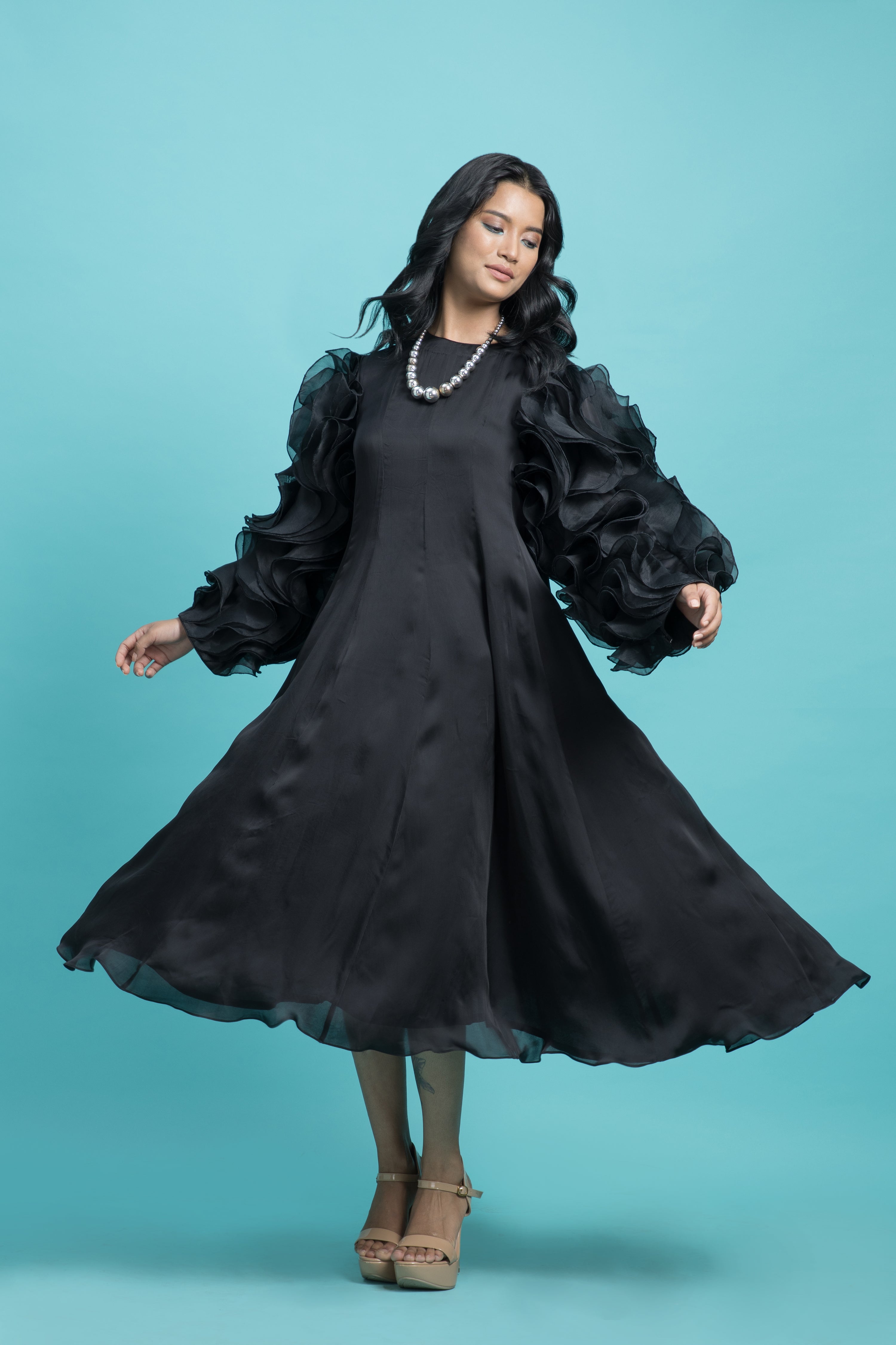 Black dress with drape heavy frill sleeves.