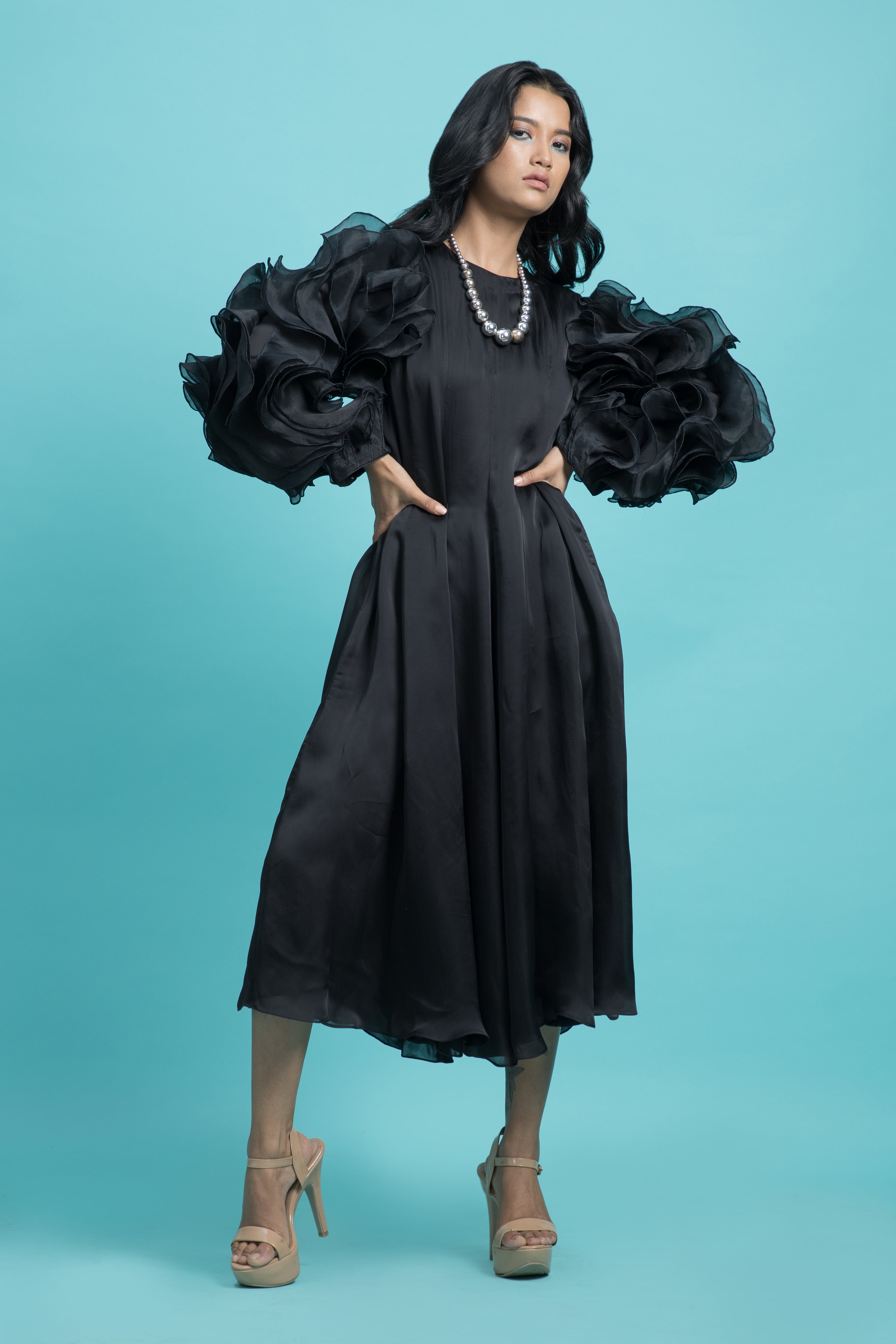 Black dress with drape heavy frill sleeves.