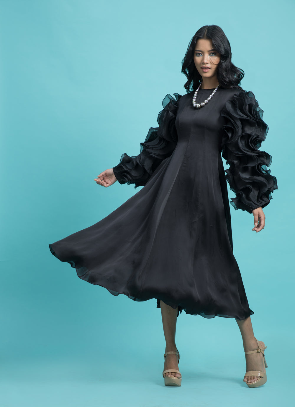 Black dress with drape heavy frill sleeves.